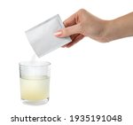Woman pouring powder from medicine sachet into glass of water on white background, closeup