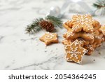 Tasty Christmas cookies on white marble table. Space for text