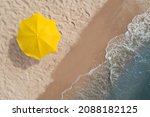Yellow beach umbrella on sandy...