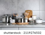 Set of different cooking utensils on grey countertop in kitchen