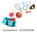 Sports bag and different gym stuff flying on white background