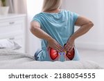 Senior woman suffering from kidney pain at home, closeup