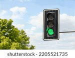 Traffic light against blue sky, space for text