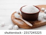 Different types of sugar on white wooden table, space for text