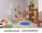 Small photo of Child`s playroom with different toys and furniture. Cozy kindergarten interior