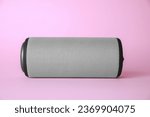 One portable bluetooth speaker on pink background. Audio equipment