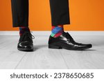 Man wearing stylish shoes and colorful socks indoors, closeup