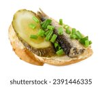 Small photo of Delicious sandwich with sprat, pickled cucumber and green onion isolated on white, above view