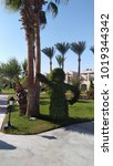 Small photo of Unholy bush in the form of a man under a palm tree, Hurghada
