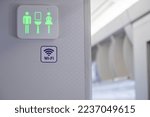 Green sign of lavatory in the airplane during fly. A Vacant of toilet indication of modern aircraft. Jet plane information restroom label.