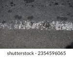 road surface texture made of asphalt with faded paint