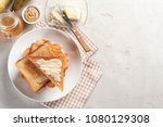 Plate with toasted bread and butter on table