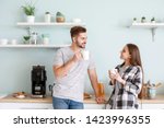 Young couple drinking hot coffee in kitchen