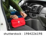 Man with first aid kit in car