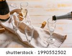Pouring of champagne in glasses on table
