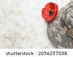 Poppy flower and uniform on grunge background. Remembrance Day