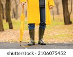 Small photo of Man wearing gumboots in park on autumn day