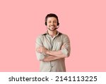 Smiling consultant of call center in headset on pink background