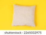 Soft pillow on yellow background