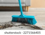 Small photo of Sweeping of rubbish with plastic broom, closeup