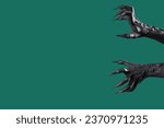 Black hands of witch with claws on green background. Halloween celebration