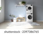 Interior of modern laundry room with washing machines and grey bench