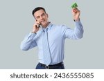 Small photo of Handsome steward with paper plane talking by mobile phone on light background