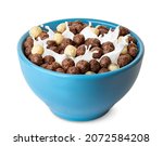 breakfast cereal with splashing milk isolated on white background. Vanilla and chocolate corn balls in blue bowl