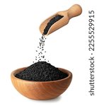 Small photo of black cumin seeds pouring out from wooden scoop in bowl isolated on white background