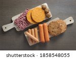 Flat lay of plant based vegetarian meat products for a plant based diet on a wooden table