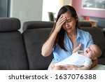 Stressed mother  depression with her crying newborn baby in her arms. Young asian mom stressful or sick concept.