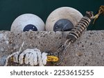 Small photo of Rubber buoys on the pier and a yellow metal shackle with rope and spring for mooring ships.