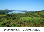 Small photo of View on summer day from O'Rourke's table, a plateau in County Leitrim, Ireland, featuring rolling green hills of farmland pastures and meadows, woodlands and still waters of Lough Gill