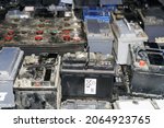 Small photo of Pallet with used car batteries waiting to be recycled in an environmentally harmful scrap yard