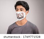Small photo of Selective focus on eyes, young man with transparent Medical face mask, to help hearing impairment or deaf people to understand lipreading during coronavirus or covid-19 outbreak