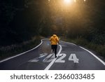 Small photo of Man running on the mountain road towards new goals in 2024. New Year 2024 with new ambitions, challenge, plans, goals and visions.