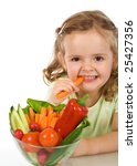 Small photo of Happy healthy little girl eating vegetables - chomping a carrot - isolated