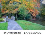 Small photo of Pedestrian walkway through Broyhill Park in autumn with colorful foliage on the trees in downtown Blowing Rock, North Carolina.