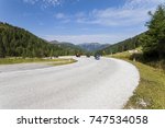 Bikers on dangerous and winding road in the high mountains