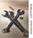 Small photo of Set of spammers tools crossed,with spring and nut isolated near by