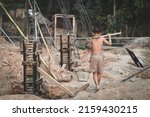 Small photo of Poor children at the construction site were forced to work. Concept against child labor. The oppression or intimidation of forced labor among children. Human trafficking.