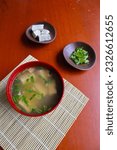 Small photo of miso soup or Japanese miso soup in bowl on the table. Japanese cuisine in the form of soup with dashi ingredients, tofu, seafood, vegetables, and topped with miso to taste