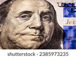 Small photo of Benjamin Franklin's face on the US 100 dollar bill. Closeup of Ben Franklin on a one hundred dollar bill. Benjamin Franklin portrait from hundred dollar bill macro