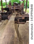 Small photo of McDonough, Georgia / USA - June 9, 2019: A view of replicas of components of the saw mill at Miller's Mill in McDonough, GA.