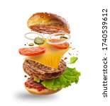Small photo of Burger with flying elements. Delicious burger with flying ingredients isolated on white background. Flying Burger Slices