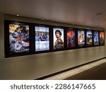 Small photo of Honolulu - March 11, 2022: Row of movie posters including Jujusu Kaisen, The worst person in the world, Cyrano, Uncharted, Dog, Spider-Man, and Batman on wall outside the movie theater.