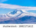 Clouds on a volcanic Erciyes mount in Kayseri. Snowy scarlet mountain. Erciyes is a large volcano, reaching a height of 3,864 m it the highest mountain and most voluminous volcano of Central Anatolia
