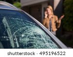Woman Phoning For Help After Car Windshield Has Broken