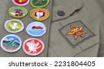 Small photo of Old Boy Scout Uniform with Star Symbol and Colorful Merit Badge Sash.