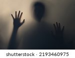 Terrifying blurry ghostly shadow of a man with flowing hair. Silhouette of a ghost, monster, alien, creature. The concept of fear, horror, scary, hallucination, psycho nightmare, halloween festival.